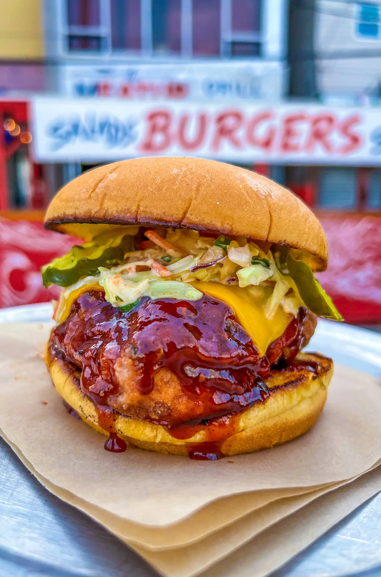 Bacon cheeseburger from The Meat Up Grill, layered with melted cheese and fresh ingredients.